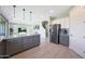 Kitchen with granite countertops and stainless steel appliances opens to the living room and dining area in a flowing floor plan at 9750 E Radioactive Dr, Mesa, AZ 85212