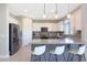 Bright kitchen features granite countertops, a breakfast bar, stainless steel appliances, and opens to the dining area at 9750 E Radioactive Dr, Mesa, AZ 85212