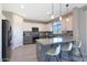 Stylish kitchen featuring white cabinetry, granite countertops, and a central island with barstool seating at 9750 E Radioactive Dr, Mesa, AZ 85212