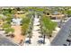 Aerial view of community park with trees, sidewalks, a modern building, and colorful playground features at 9750 E Radioactive Dr, Mesa, AZ 85212