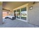 Covered patio with large sliding glass doors and comfortable outdoor seating at 9750 E Radioactive Dr, Mesa, AZ 85212