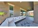 Covered patio featuring a large sectional sofa, providing a comfortable outdoor living space at 9750 E Radioactive Dr, Mesa, AZ 85212