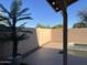 The backyard boasts ample space with concrete pavers, complemented by potted palm trees at 9853 W Pontiac Dr, Peoria, AZ 85382