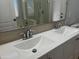 Bathroom featuring a double sink vanity with elegant fixtures and white countertop at 9853 W Pontiac Dr, Peoria, AZ 85382