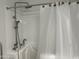 Accessible walk-in bathtub featuring a chrome showerhead and updated fixtures at 9853 W Pontiac Dr, Peoria, AZ 85382