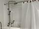 Accessible walk-in tub with shower head, white walls, and brushed nickel fixtures at 9853 W Pontiac Dr, Peoria, AZ 85382