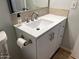 Bathroom vanity with brushed nickel faucet, white countertop and matching white cabinets at 9853 W Pontiac Dr, Peoria, AZ 85382
