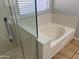 Modern bathroom featuring a soaking tub next to a glass-enclosed shower at 9853 W Pontiac Dr, Peoria, AZ 85382