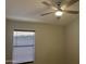Bedroom with a ceiling fan and light and natural light entering through a window at 9853 W Pontiac Dr, Peoria, AZ 85382