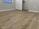 Bedroom features new laminate flooring, light gray walls, white trim, and a window providing natural light at 9853 W Pontiac Dr, Peoria, AZ 85382