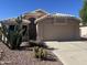 Charming single-story home featuring desert landscaping, neutral stucco, and a two-car garage at 9853 W Pontiac Dr, Peoria, AZ 85382