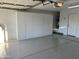Spacious garage features epoxy floors and ample storage with wall to wall cabinets at 9853 W Pontiac Dr, Peoria, AZ 85382