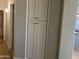 Hallway with a large set of cabinets, lighting, and new paint at 9853 W Pontiac Dr, Peoria, AZ 85382