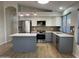 Updated kitchen featuring modern stainless steel appliances, stylish countertops, and gray and white cabinetry at 9853 W Pontiac Dr, Peoria, AZ 85382