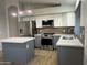Stylish kitchen with stainless steel appliances, an island, and sleek countertops at 9853 W Pontiac Dr, Peoria, AZ 85382