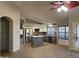 Open-concept layout with kitchen island, stainless appliances, and wood-look flooring at 9853 W Pontiac Dr, Peoria, AZ 85382