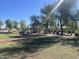 Picturesque park view featuring picnic tables, mature trees, and lush green grass at 9853 W Pontiac Dr, Peoria, AZ 85382