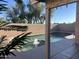 An inviting in-ground pool with a water feature is surrounded by mature trees at 9853 W Pontiac Dr, Peoria, AZ 85382