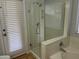 Contemporary bathroom showcases a glass-door shower adjacent to a relaxing soaking tub at 9853 W Pontiac Dr, Peoria, AZ 85382