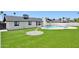 Expansive backyard with lush, green artificial turf, a pool, and a stepping stone design at 1030 E Wescott Dr, Phoenix, AZ 85024