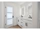 Modern bathroom featuring double sinks, sleek white cabinets, and illuminated mirrors at 1030 E Wescott Dr, Phoenix, AZ 85024