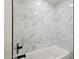 A bathroom featuring modern fixtures, white tile, and a built-in tub at 1030 E Wescott Dr, Phoenix, AZ 85024