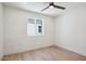 Bright bedroom with a ceiling fan, window, and stylish wood flooring at 1030 E Wescott Dr, Phoenix, AZ 85024