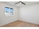 Bright bedroom with a ceiling fan, window, and stylish wood flooring at 1030 E Wescott Dr, Phoenix, AZ 85024