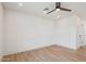 A bright, spacious bedroom with wood-style flooring and a modern ceiling fan at 1030 E Wescott Dr, Phoenix, AZ 85024