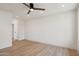 A modern bedroom featuring wood floors and a contemporary ceiling fan and door at 1030 E Wescott Dr, Phoenix, AZ 85024