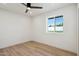A bedroom featuring a ceiling fan, window, and wood flooring at 1030 E Wescott Dr, Phoenix, AZ 85024