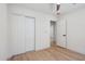 A bedroom featuring sliding closet doors, a ceiling fan, and light-colored wood floors at 1030 E Wescott Dr, Phoenix, AZ 85024