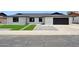 Charming, single-story home featuring updated brickwork, a dark roof, attached garage, and green synthetic front lawn at 1030 E Wescott Dr, Phoenix, AZ 85024