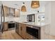 Updated kitchen with stainless steel appliances, marble countertops, and an island with built-in microwave at 1030 E Wescott Dr, Phoenix, AZ 85024