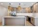 Bright kitchen features a marble countertop island, modern appliances, and stylish pendant lighting at 1030 E Wescott Dr, Phoenix, AZ 85024