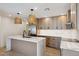 Bright kitchen features a marble countertop island, stainless steel appliances, and stylish pendant lighting at 1030 E Wescott Dr, Phoenix, AZ 85024