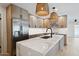 Bright kitchen features a marble countertop island, stainless steel appliances, and stylish pendant lighting at 1030 E Wescott Dr, Phoenix, AZ 85024