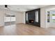 Light-filled living room showcasing wood floors, a modern fireplace, ceiling fan, and a sliding glass door leading outside at 1030 E Wescott Dr, Phoenix, AZ 85024