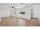 Bright living room with wood floors, ceiling fan, recessed lighting, and big windows providing plenty of natural light at 1030 E Wescott Dr, Phoenix, AZ 85024