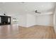 Spacious living room with wood floors, a modern fireplace, ceiling fans, and recessed lighting with ample space at 1030 E Wescott Dr, Phoenix, AZ 85024