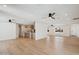 Open-concept living area with wood floors, recessed lights, ceiling fans, with a partial view of kitchen area at 1030 E Wescott Dr, Phoenix, AZ 85024