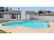Backyard pool showcasing blue tile, a spa, and exterior view of a white-painted brick home at 1030 E Wescott Dr, Phoenix, AZ 85024