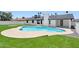 Backyard pool featuring blue tile, a spa, and green artificial turf, complemented by a white-painted brick home at 1030 E Wescott Dr, Phoenix, AZ 85024