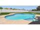 Inviting blue-tiled pool with tanning deck surrounded by lush, green artificial turf, and a white block fence at 1030 E Wescott Dr, Phoenix, AZ 85024