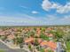 Aerial view showcasing neighborhood with mountain views, lush vegetation, and red tiled roofs at 10580 E Bella Vista Dr, Scottsdale, AZ 85258