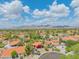 Aerial view showcasing the house, surrounding neighborhood, mature landscaping, and mountain views at 10580 E Bella Vista Dr, Scottsdale, AZ 85258