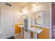 Bright bathroom featuring double pedestal sinks, decorative mirrors, and warm-toned walls at 10580 E Bella Vista Dr, Scottsdale, AZ 85258