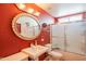 Bathroom with red walls, a pedestal sink, toilet and a shower-tub combo at 10580 E Bella Vista Dr, Scottsdale, AZ 85258