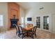 Elegant dining area with fireplace and a view to the french doors at 10580 E Bella Vista Dr, Scottsdale, AZ 85258