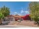 Inviting one-story home with a lush garden, desert landscaping, and a two-car garage at 10580 E Bella Vista Dr, Scottsdale, AZ 85258